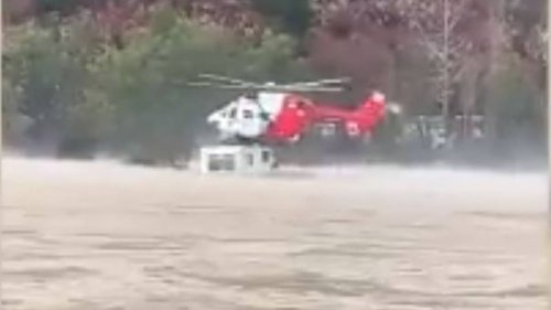 Watch: Rescue helicopter plucks traveller from roof of campervan in flooded river - NZ Herald