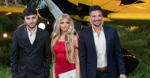 Princess Andre stuns in red off-the-shoulder dress as she attends glitzy film premiere with dad Peter and brother Junior
