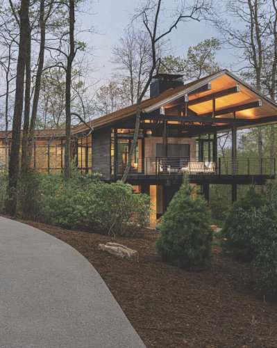 A glass house hidden among the trees in North Carolina’s Blue Ridge Mountains