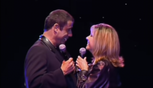 Olivia Newton-John (RIP) Reunites with Grease Co-Star John Travolta to Sing “You’re The One That I Want” (2002)