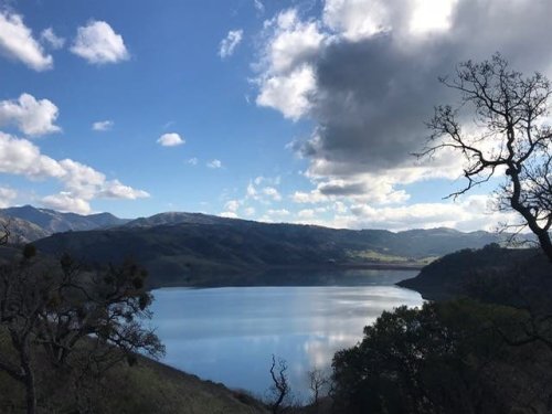 Calaveras Reservoir Glows Beneath Backlit Clouds: Photo