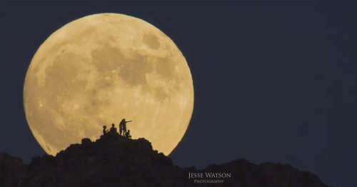 Silhouettes of a Hiking Family Framed Inside a Rising Full Moon