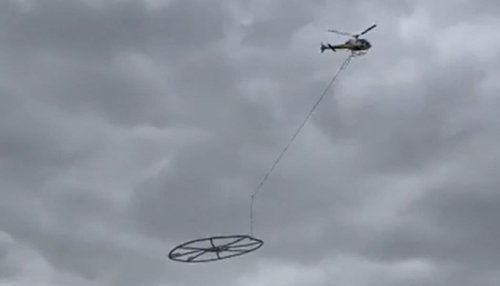 'Mystery' in the sky as video captures helicopter carrying giant metal ring over city