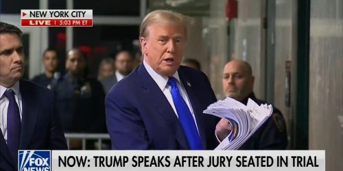 Trump awkwardly brandishes printed news stories after full day of criminal trial