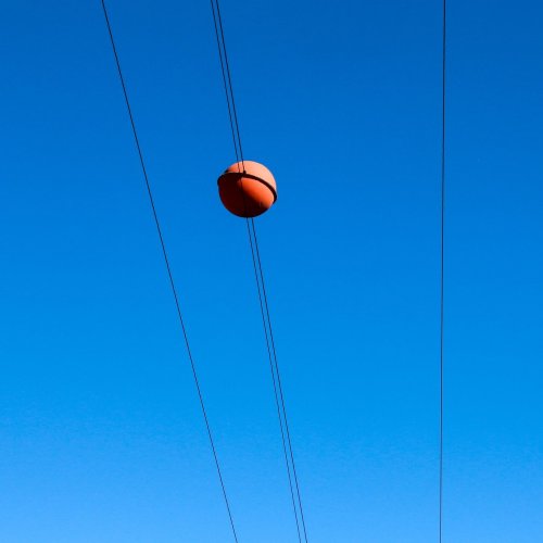 This Is Why You See Those Colored Balls Hanging on Power Lines