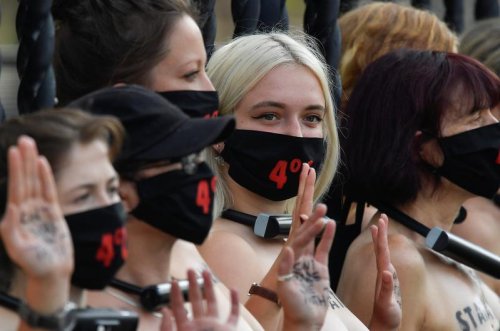 Bare-chested women lock themselves to UK parliament in climate protest