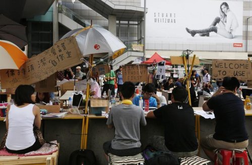 Hong Kong's leader warns protesters as tent city sprouts up