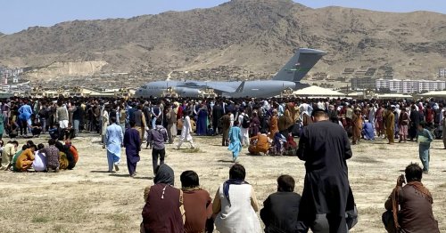 Body found in landing gear of U.S. plane people clung to as it left Kabul