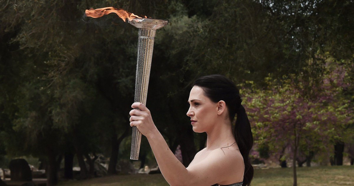 Paris flame lit in ancient Olympia ceremony, starting torch relay to France