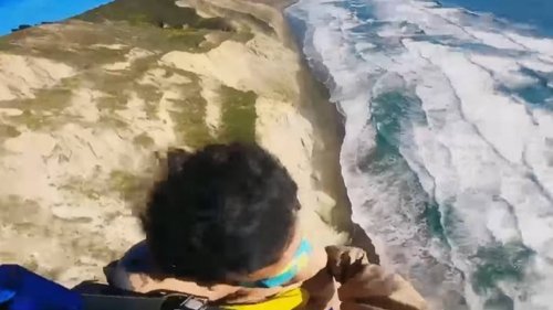 Fisherman alerts rescuers to man dangling 250 feet over ocean, California cops say