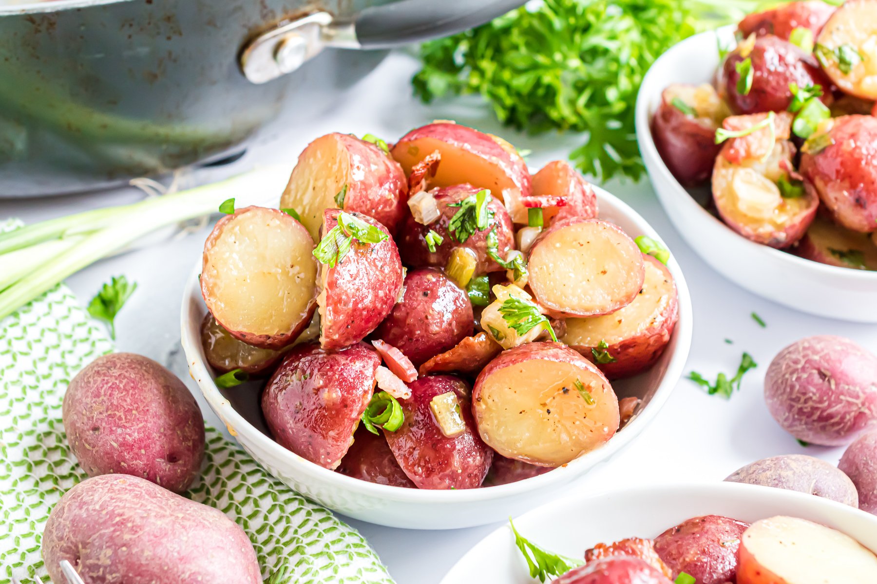 Warm Potato Salad Recipe featuring baby red potatoes, crumbled bacon, green onions, and a warm mustard vinaigrette dressing.