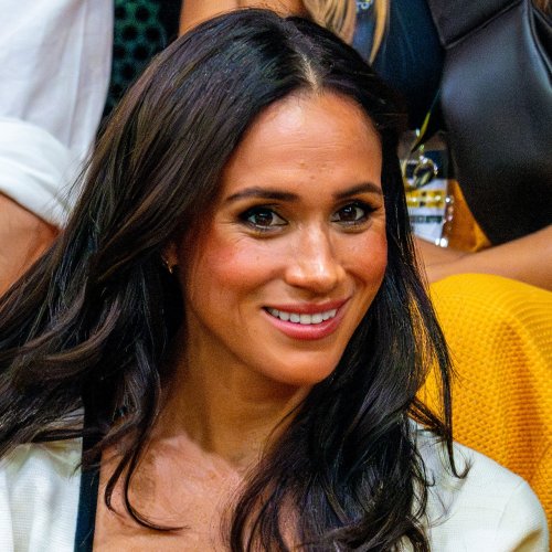 Meghan Markle Glows In A Floral Cape For Art Museum Event With Prince Harry & Her Mom