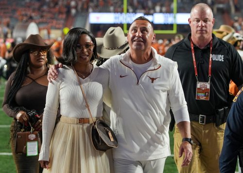 Steve Sarkisian's wife, Loreal, catches eyeballs in vibrant all-white costume as Texas coach poses in cowboy hat & blue jeans