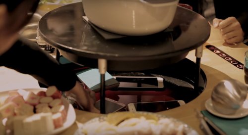 Table heats food with smartphones, so diners can't use them