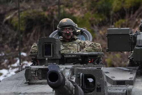 William rides in tank on visit to British troops helping defend Estonia