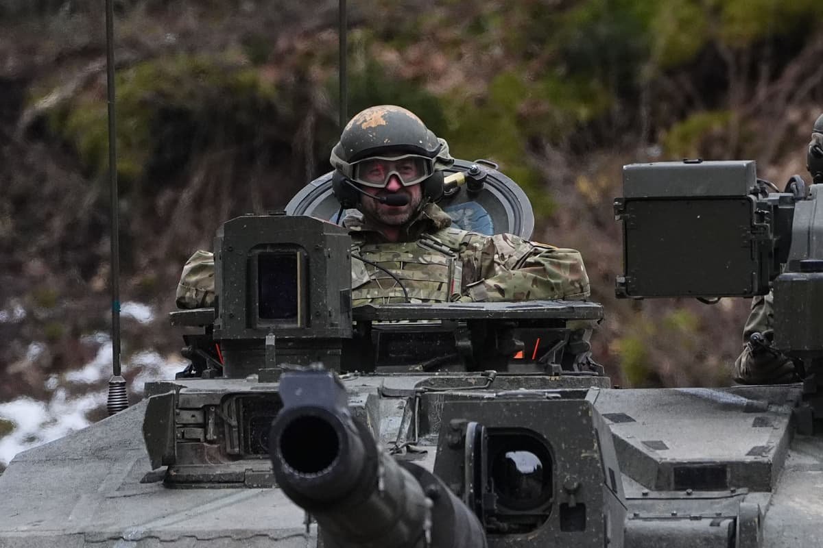 William rides in tank on visit to British troops helping defend Estonia