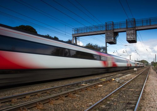 Train hits tractor and trailer on level crossing causing injuring multiple passengers