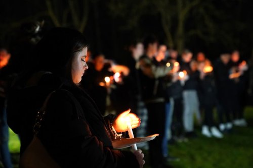 Candlelit vigil held for girl, four, who was mauled to death by pet dog