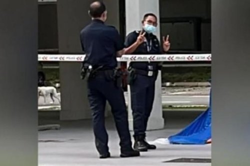 Police apologise after officer poses next to blue death tent