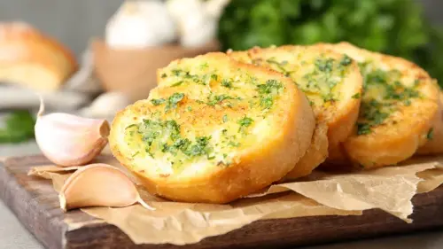 These Delicious Herbs Will Amp Up The Flavor In Your Garlic Bread
