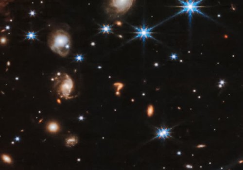 Riddle me this: What is the deep-space question mark astronomers found in this Webb NIRCam photo?
