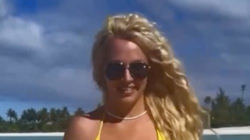 BEACH BABE Britney Spears nearly suffers wardrobe malfunction in very tiny yellow bikini as star rocks beach look in sexy video