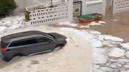 FLOOD HELL Watch moment Spanish holiday hotspot is flooded by river of ICE after hail storm as torrential rain batters region