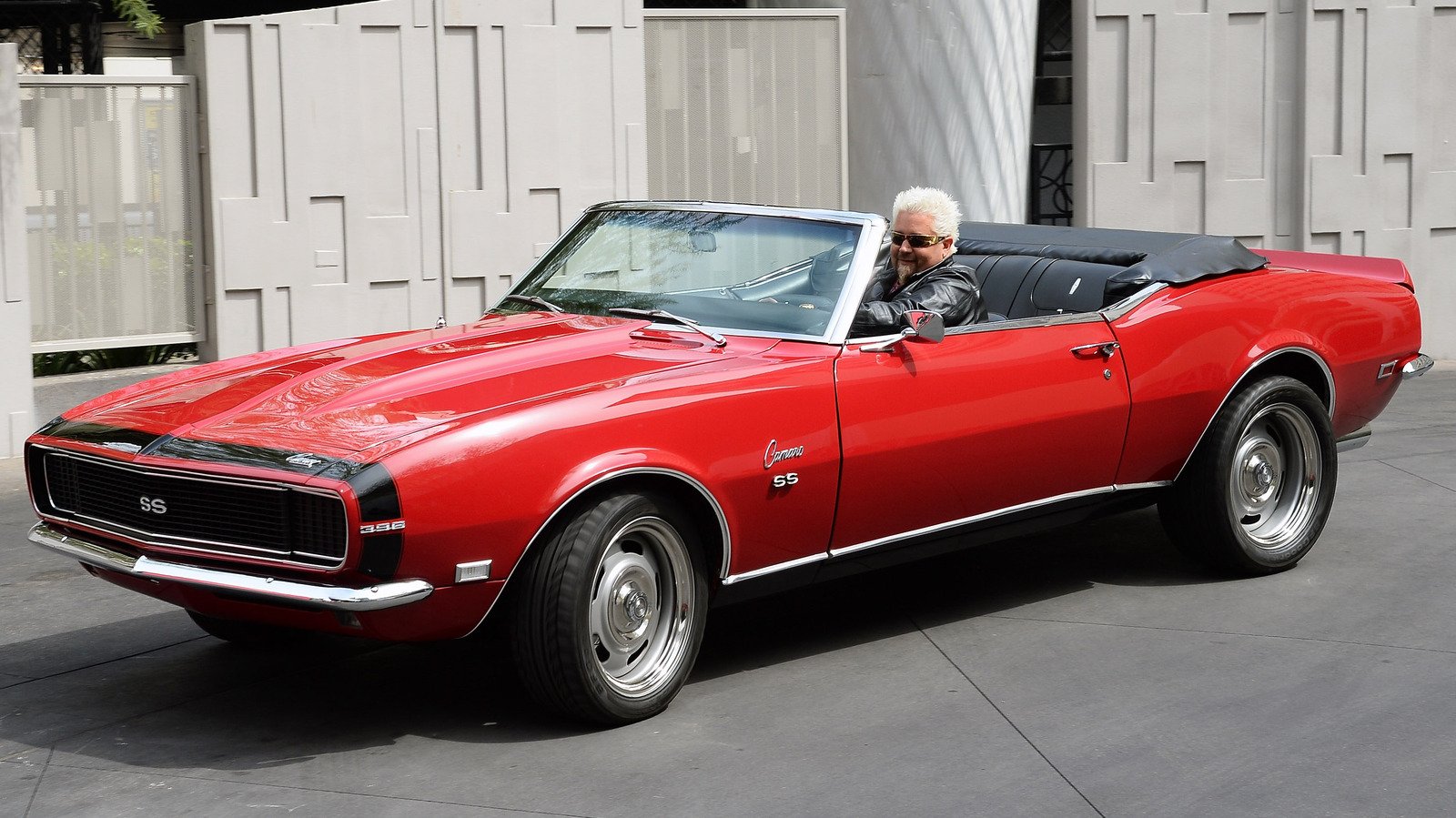 Guy Fieri Doesn't Really Drive The Red Camaro To Every Diners, Drive-Ins, And Dives Stop