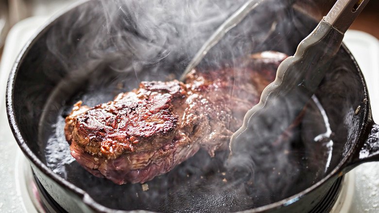 Why You Should Use Tongs To Serve Steak