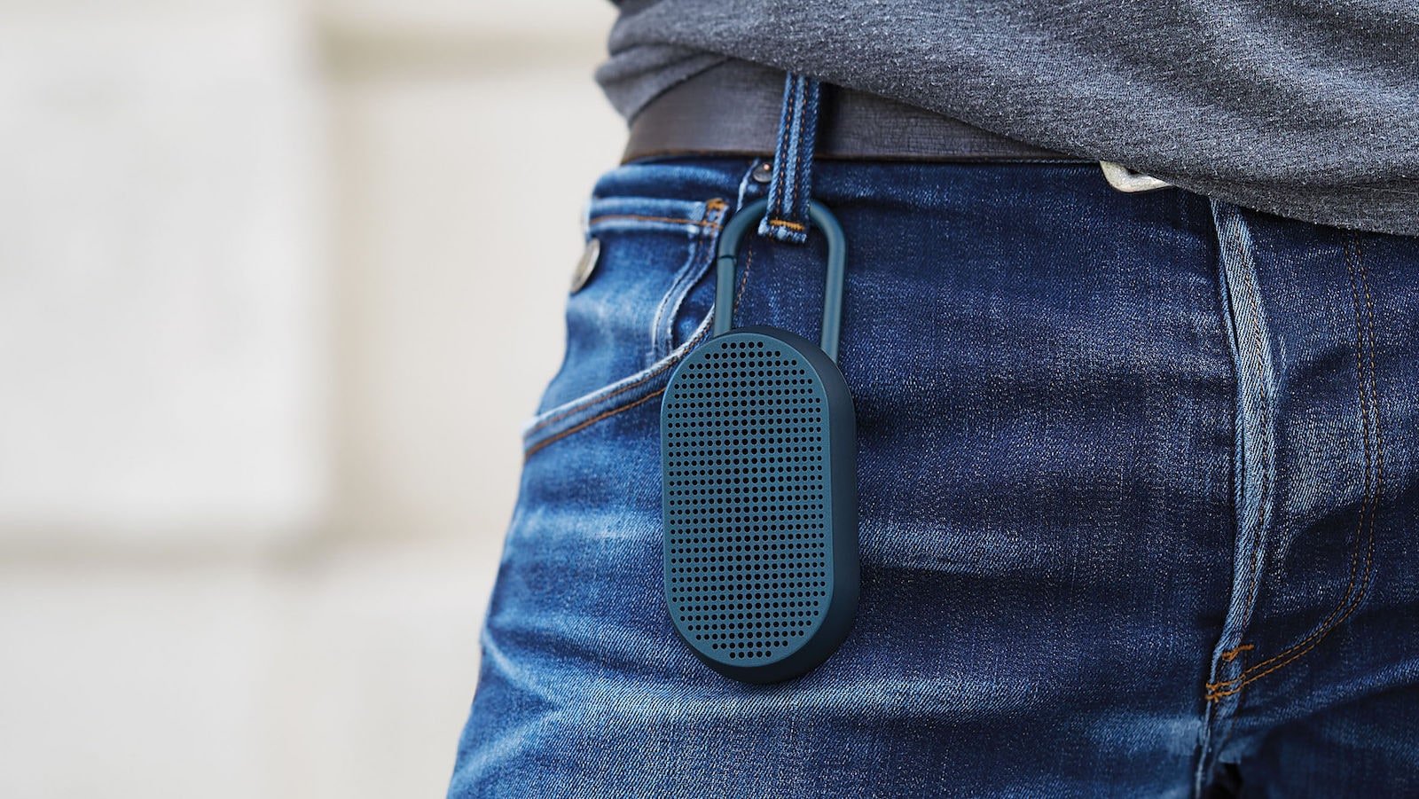 Lexon Mino T Bluetooth speaker with an integrated carabiner clips to clothes, bags, & more