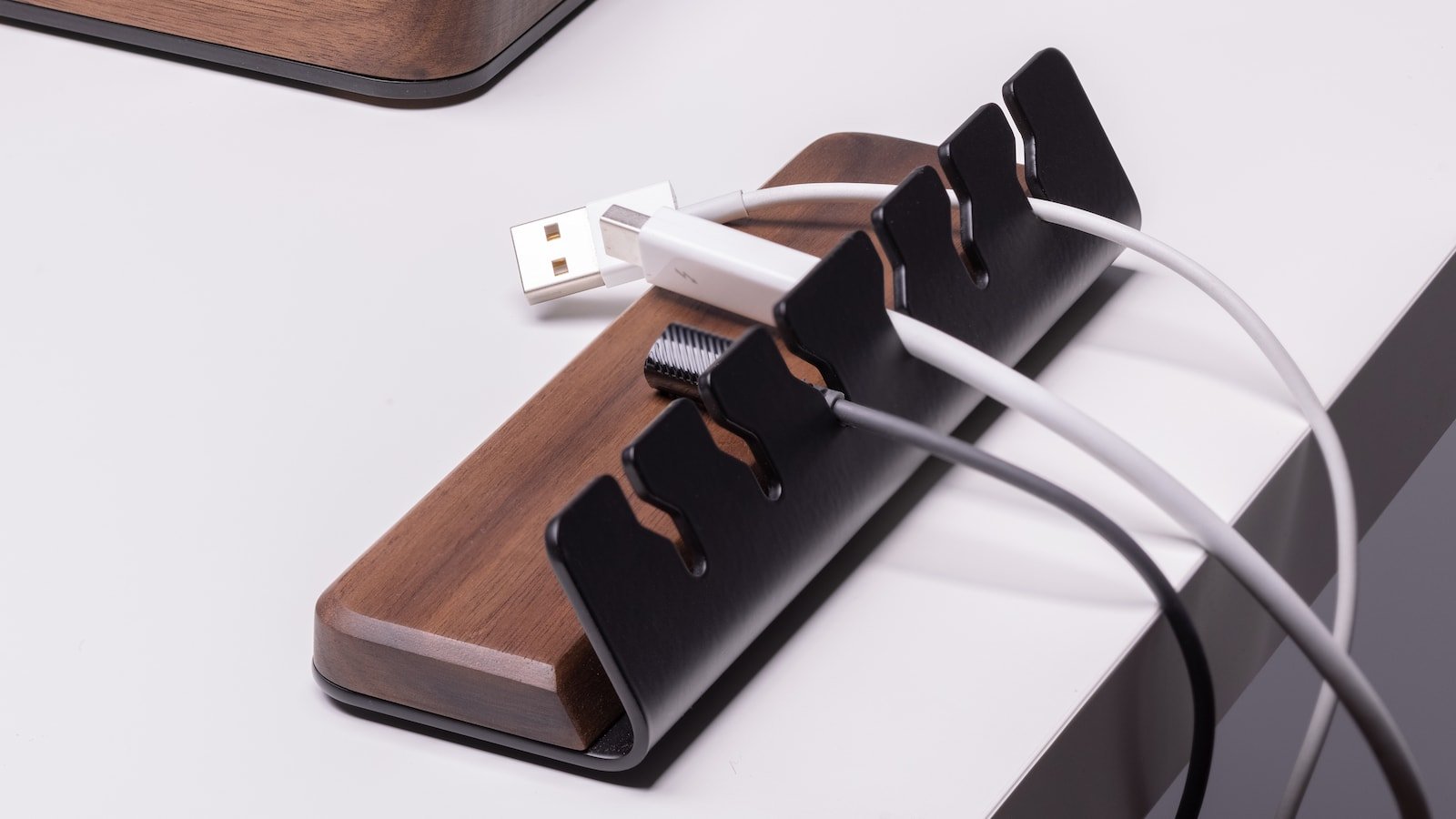 Batelier Handicraft Wood Cable Organizer has a handmade walnut base and holds 6 cords