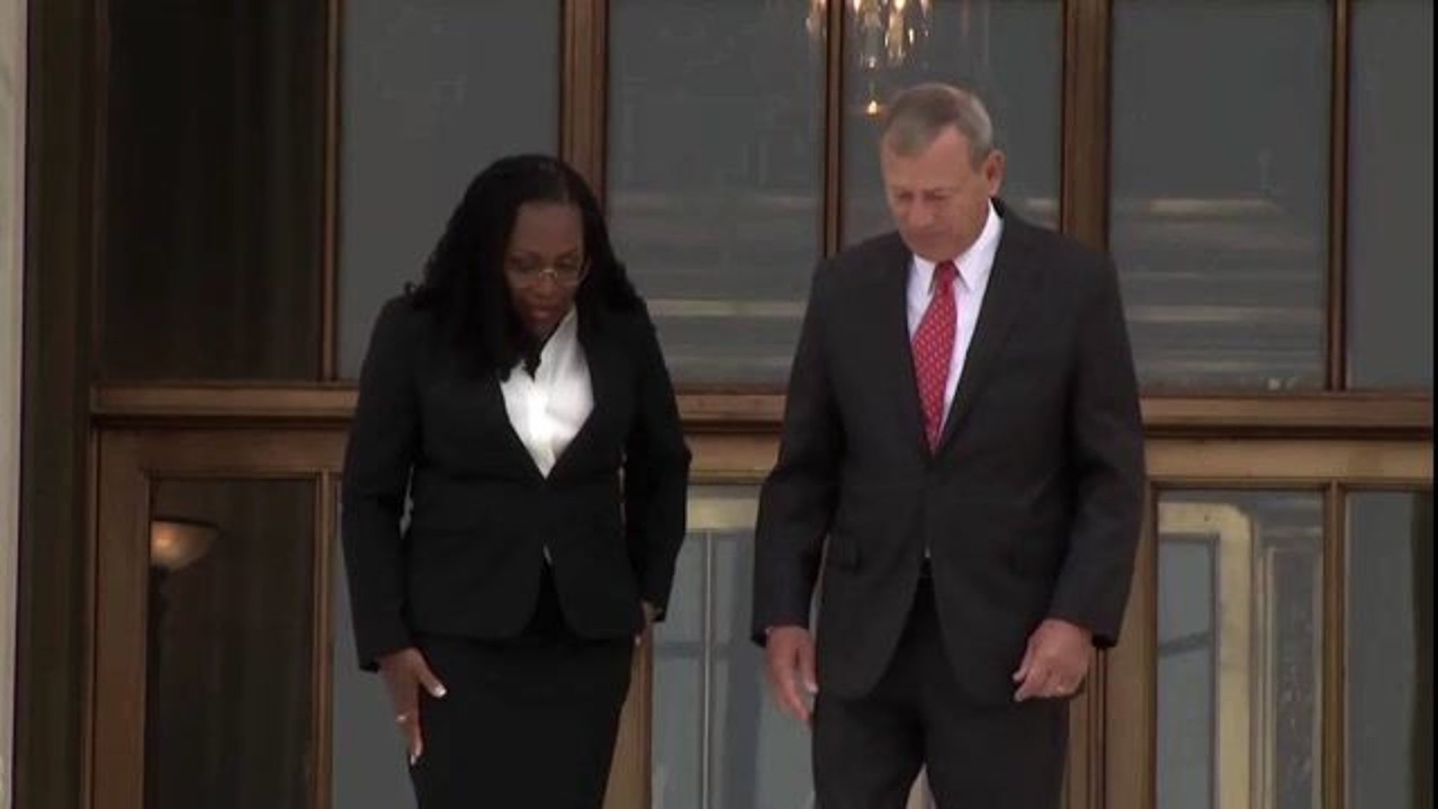Chief Justice Roberts and Justice Brown Jackson walk down the steps of the Supreme Court after her investiture ceremony.