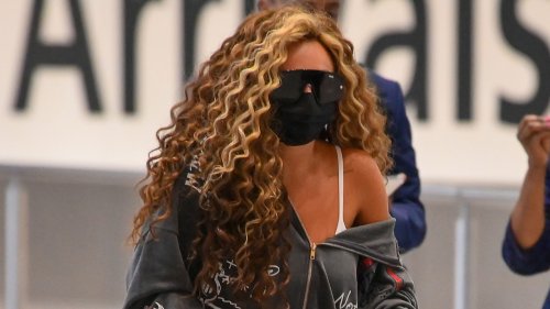 Jesy Nelson looks downcast as she arrives in UK hiding face in mask and sunnies