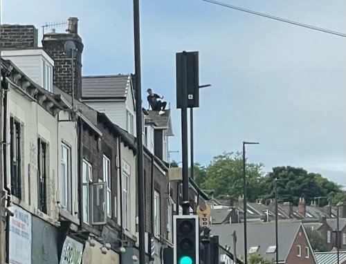 Major Sheffield road reopens after man who spent 12 hours on rooftop comes down safely