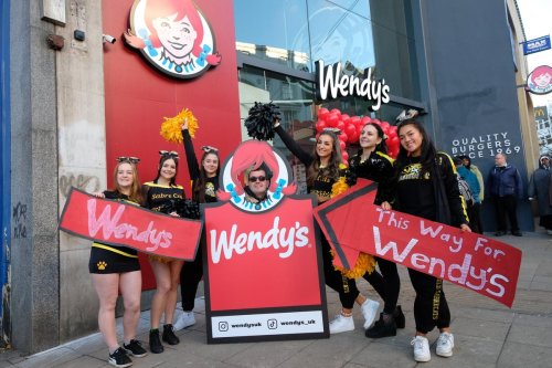 Watch as Wendy's first customer bursts through entrance cover in restaurants showtime opening event