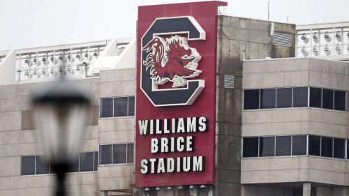 Legendary coach’s wife fell on an escalator at USC’s stadium. A lawsuit was settled for $1M