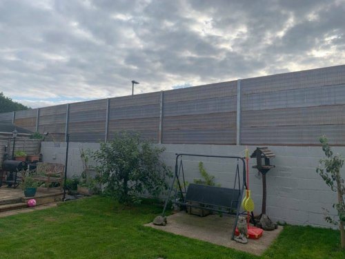 Furious residents blast huge 3.5 metre fence leaving their homes 'like prisons'