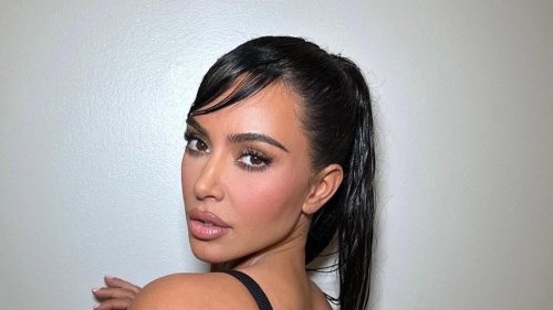 Kim Kardashian goes naked in just a towel and shows off oiled-up skin as she’s hand-fed by mystery man in steamy video