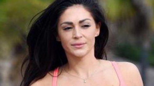 Casey Batchelor shows off pert bottom as she does the SPLITS on sandy beach after 4st baby weight loss