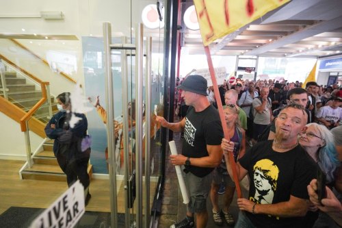 Anti-vax protesters try to storm Covid test centre as thousands join demos