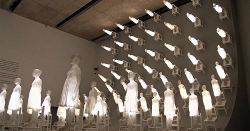 A Massive Wave of Luminous Figures Scales a Dark Wall in Ataraxia by Eugenio Cuttica