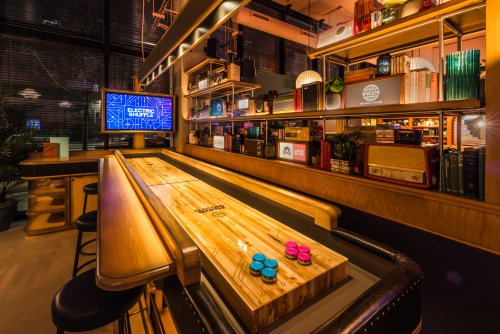 This neon-lit shuffleboard bar from London is officially open in Chicago: see inside