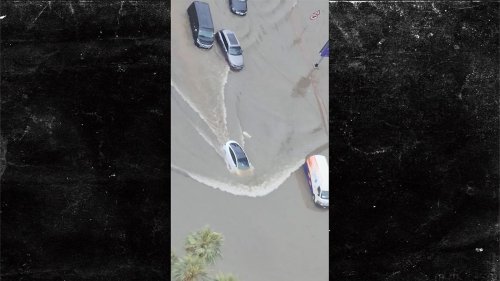 Aerial Shot Of Tesla Moving Through Flood Water In Dubai