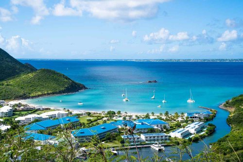 This Caribbean Island Has a Famous Luxury Hotel, a Waterfront Airport, and the 'Most Extreme Beach in the World'