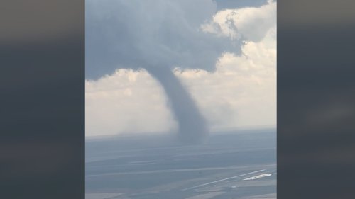 Passenger captures moment as plane lands next to tornado in Denver: Watch