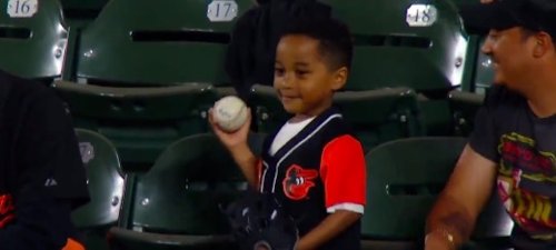 A young Orioles fan threw a ball back on the field and then some other fans did something awesome