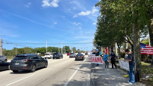Protesters denounce Musk, DOGE outside Tesla showroom