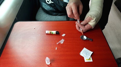 What's the idea behind "harm reduction" in the opioid epidemic?
