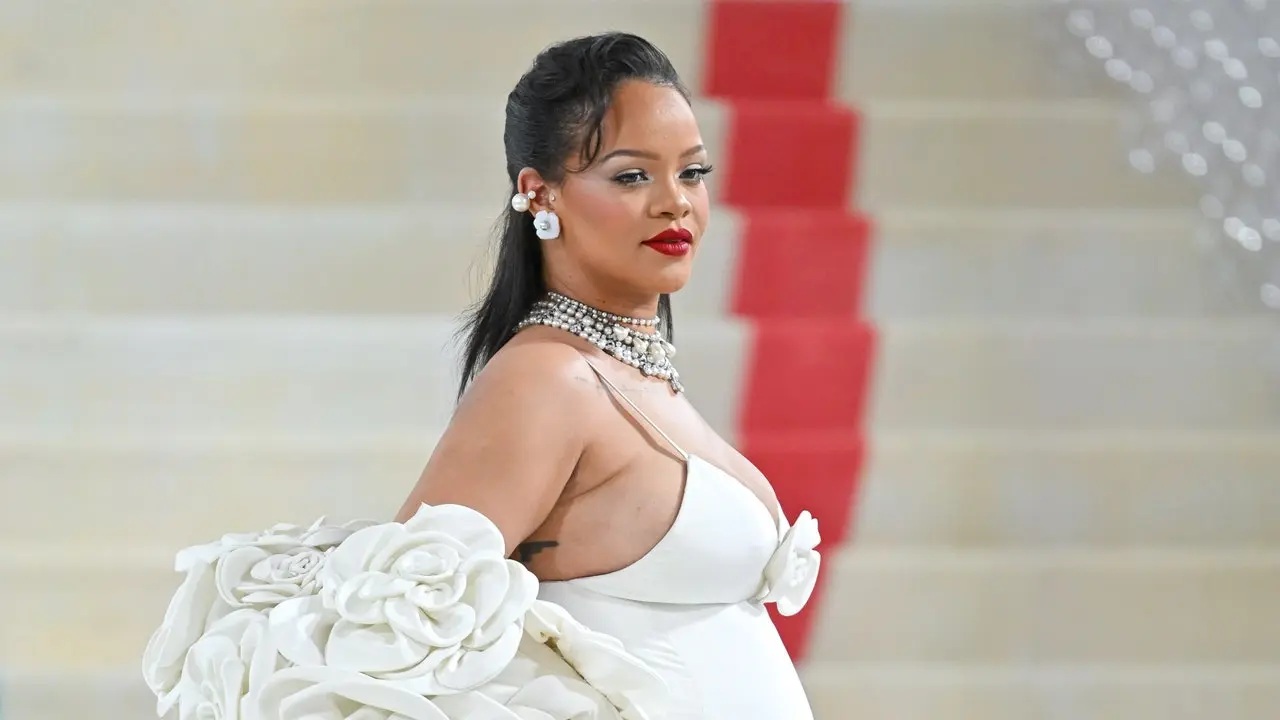 Rihanna Flexes Baby Bump at Pharrell's Louis Vuitton Debut Show – Footwear  News