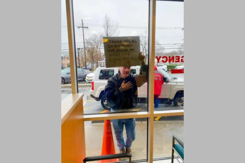 Mystery man leaves doctors, nurses in tears as he holds sign up to hospital window
